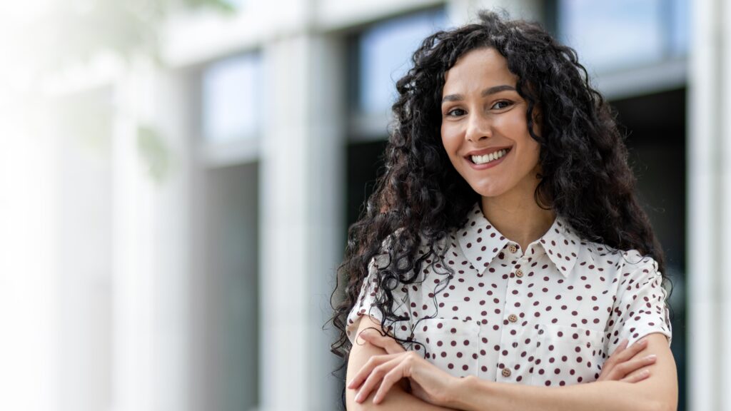 Confident businesswoman standing with arms crossed