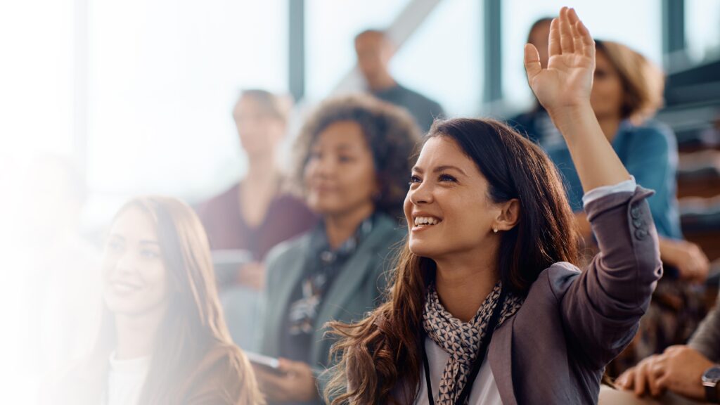 Happy entrepreneur raising her hand